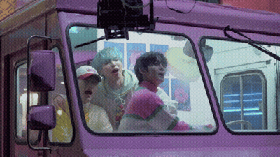 Group Of People Looking Out Of Purple Bus GIF