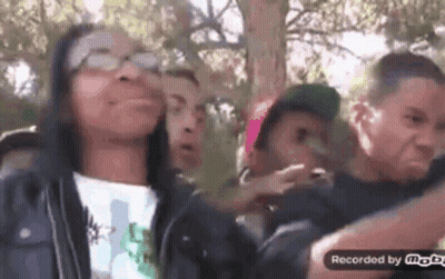 Group Of People Making Funny Faces In Park GIF