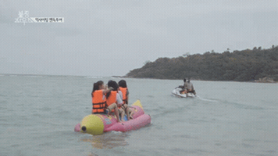 Group Of People On A Banana Boat In The Ocean GIF