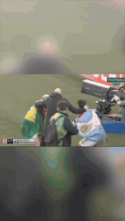 Group Of People On Field With Sign Saying Football GIF