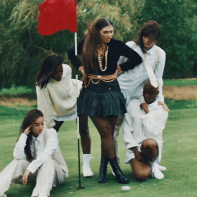 Group Of People On Golf Course With Red Flag GIF