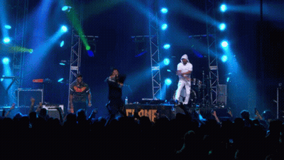 Group Of People On Stage With Blue Lights GIF