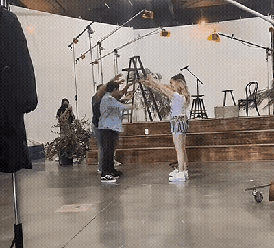 Group Of People On Stage With Ladder GIF