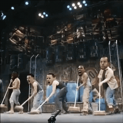 Group Of People On Stage With Mops GIF