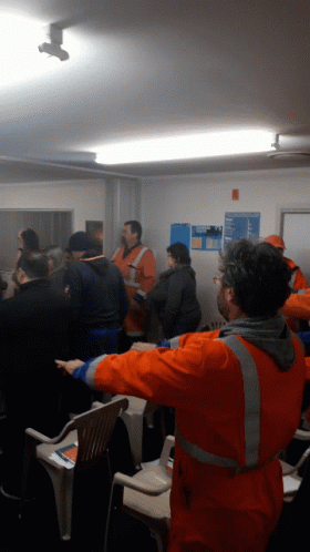 Group Of People One Man In Orange Vest GIF