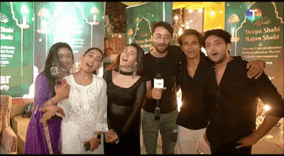Group Of People Posing With Man Holding Microphone GIF