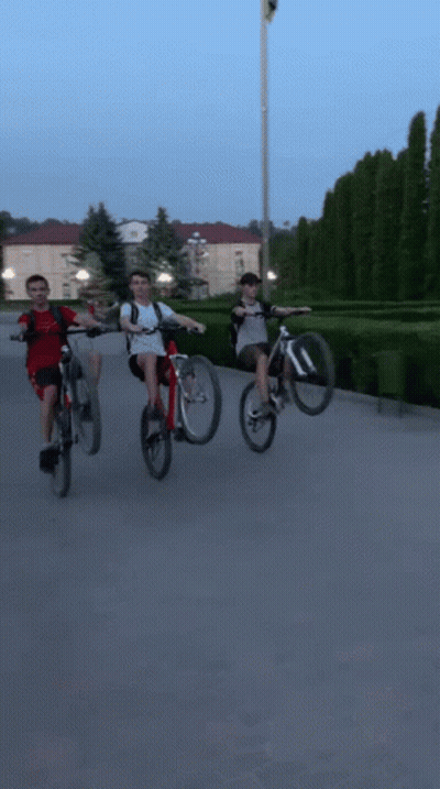 Group Of People Riding Bicycles On Street GIF