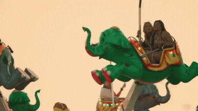 Group Of People Riding Elephant At Carnival GIF