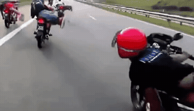 Group Of People Riding Motorcycles Down Highway GIF