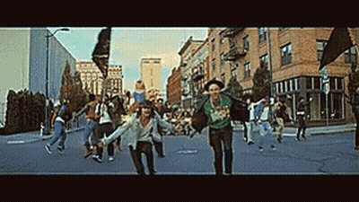 Group Of People Running Down City Street Holding Hands GIF