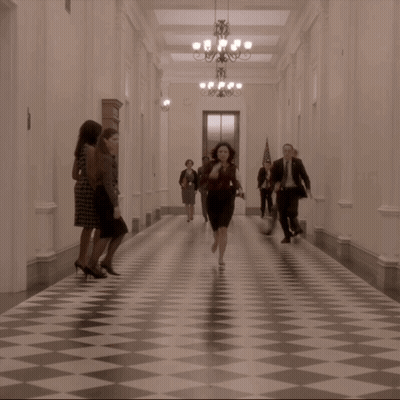 Group Of People Running Down Hallway GIF