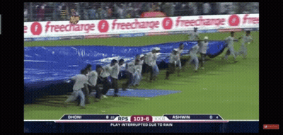 Group Of People Running On Field With Freecharge Ads GIF