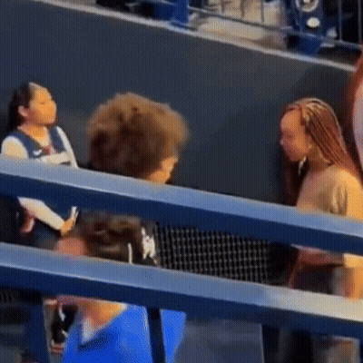 Group Of People Sitting And Talking In Stadium GIF