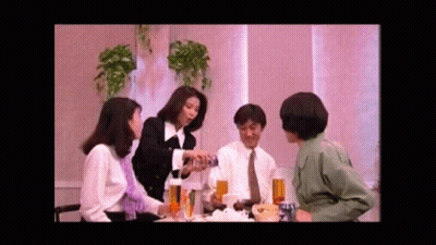 Group Of People Sitting Around Table With Drinks And Food GIF