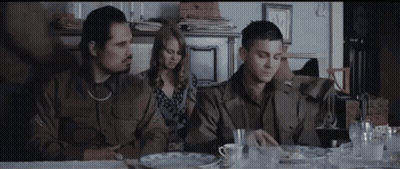 Group Of People Sitting At Table In Living Room GIF