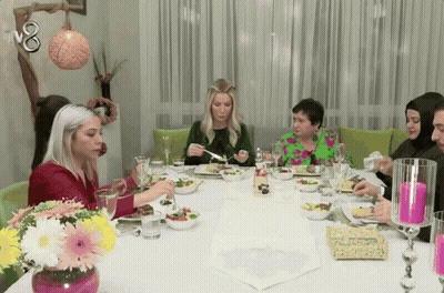 Group Of People Sitting At Table With TV8 GIF