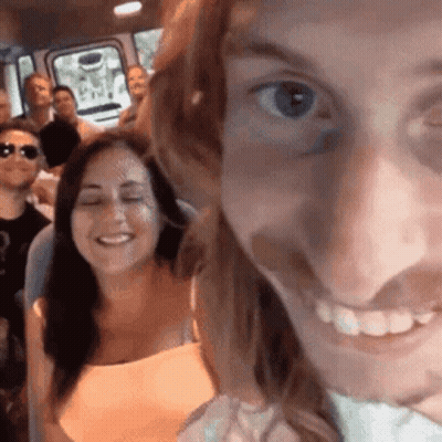 Group Of People Sitting In Bus Woman Smiling At Camera GIF