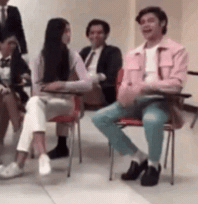 Group Of People Sitting In Chairs Talking GIF