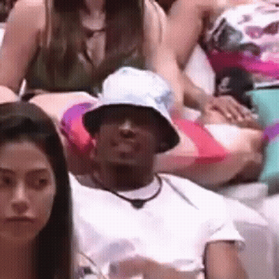 Group Of People Sitting In Room Person Wearing Hat GIF