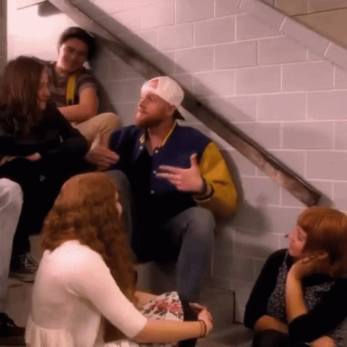 Group Of People Sitting On Stairs Talking GIF