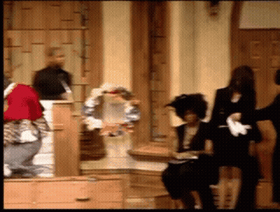 Group Of People Standing And Sitting In Front Of Door GIF