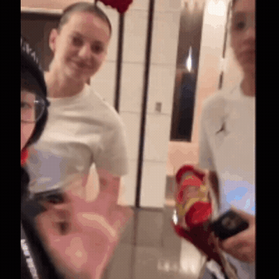 Group Of People Standing And Talking In Room GIF