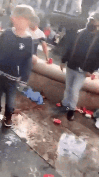 Group Of People Standing Around Couch In Crowded Room GIF