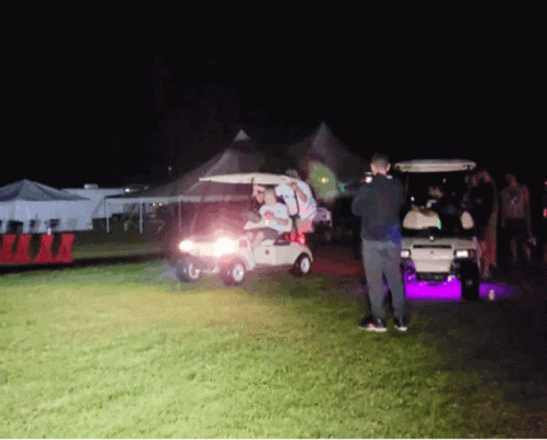Group Of People Standing Around Golf Cart GIF