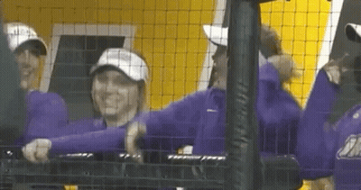 Group Of People Standing Behind Fence GIF