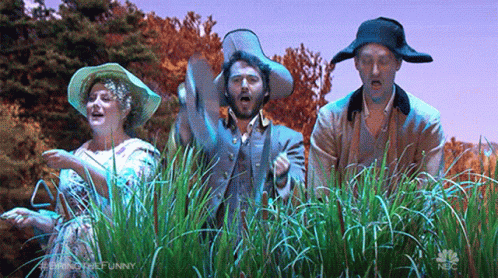 Group Of People Standing In Field Of Grass GIF