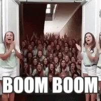 Group Of People Standing In Front Of Door With Boom Boom GIF