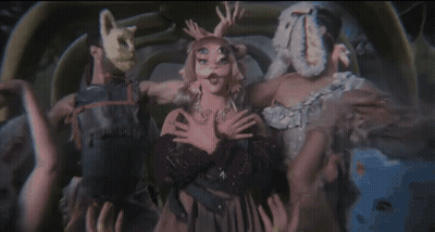 Group Of People Standing In Front Of Large Skeleton GIF