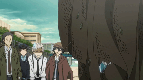 Group Of People Standing In Front Of Large Wall GIF