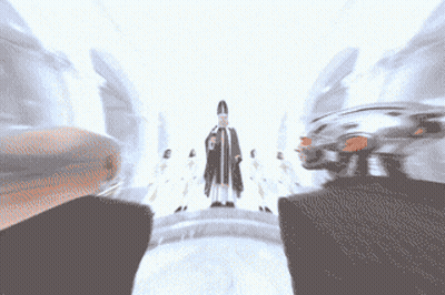 Group Of People Standing In Front Of Priest GIF