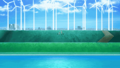 Group Of People Standing In Grassy Field With Windmills GIF