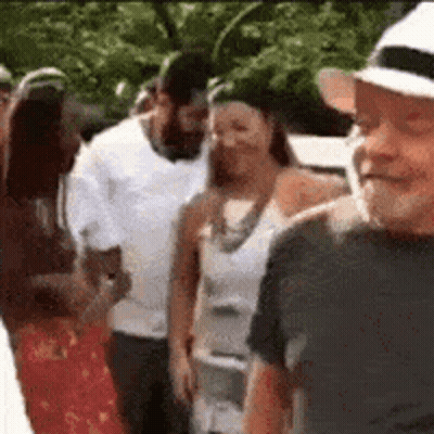Group Of People Standing In Line One Wearing Hat GIF