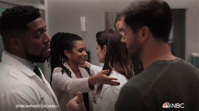 Group Of People Standing In Room With NBC GIF