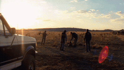 Group Of People Standing Near Van In Field GIF