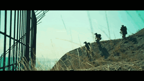Group Of People Standing On A Hill GIF