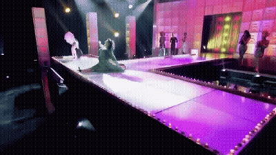 Group Of People Standing On Stage With Purple Lights GIF