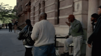 Group Of People Talking Outside Building GIF