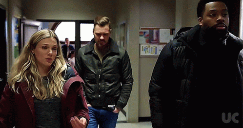 Group Of People Walking Down Hallway With UC GIF