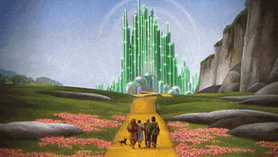 Group Of People Walking Down Yellow Road Towards Green Castle GIF