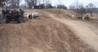 Group Of People Watching Jeep On Dirt Track GIF