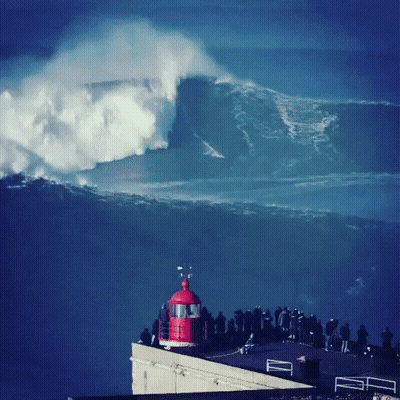 Group Of People Watching Wave Crash From Building GIF