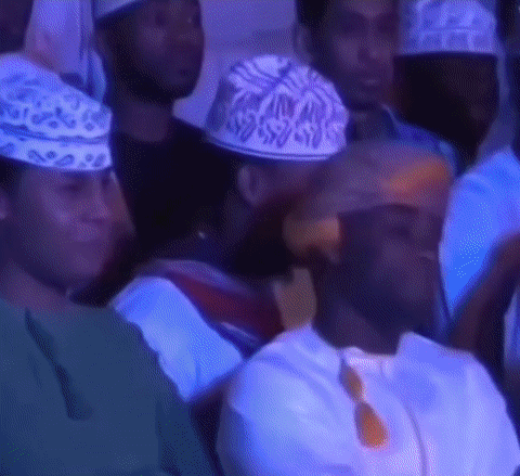 Group Of People Wearing Hats Sitting In Room GIF