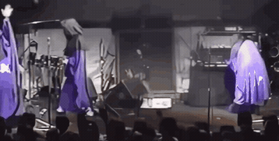 Group Of People With Purple Umbrellas On Stage GIF