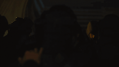 Group Of People With Spotlight In Dark Room GIF