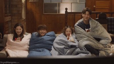 Group Of People Wrapped In Blankets Watching A Movie GIF