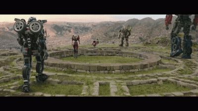 Group Of Robots Around Stone Circle In Field GIF